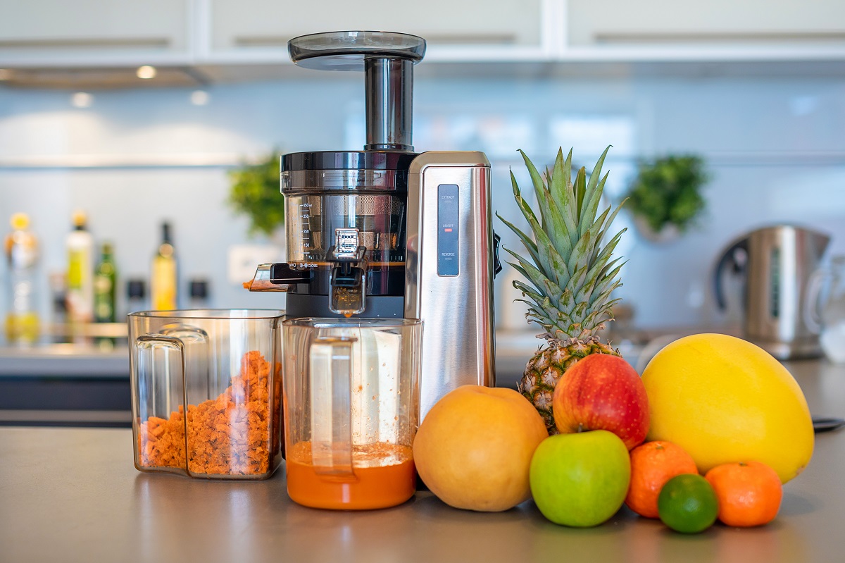 Making,Fruit,Juice,With,Juicer,Machine,At,Home,In,Kitchen,