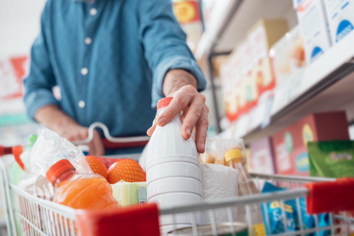Man,Doing,Grocery,Shopping,At,The,Supermarket,,He,Is,Putting