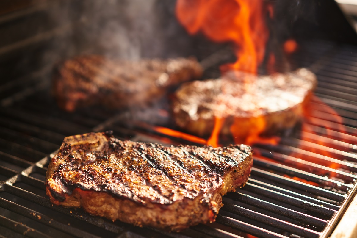 Steaks,Cooking,Over,Flaming,Grill