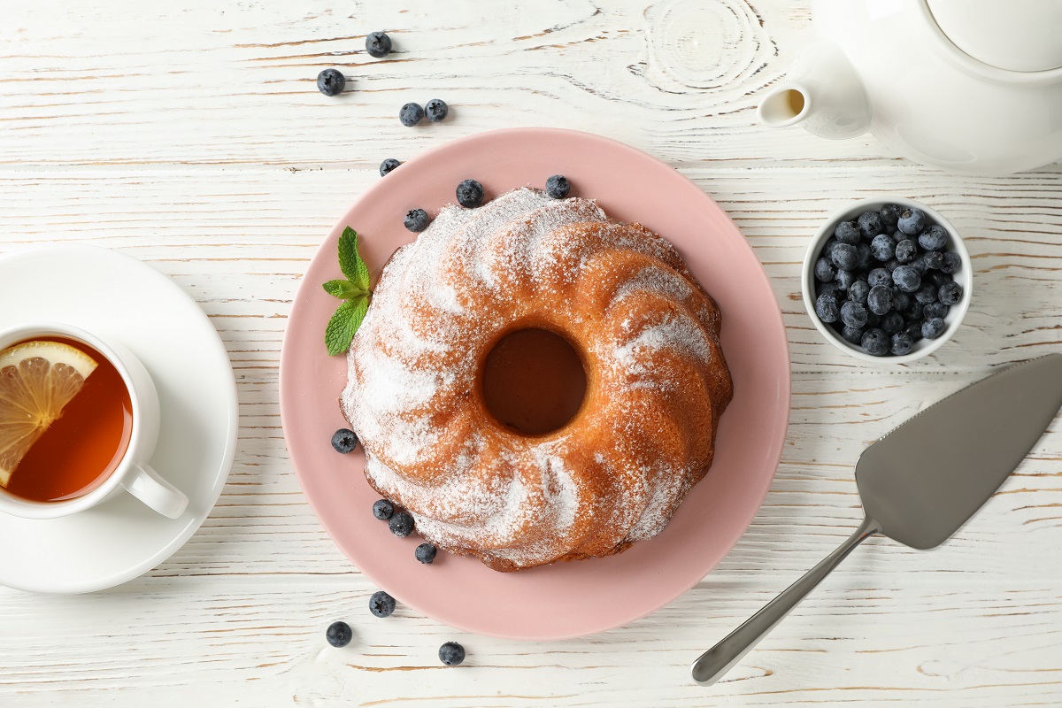 Cake,With,Powder,Sugar,And,Blueberry,On,Wooden,Background,,Top