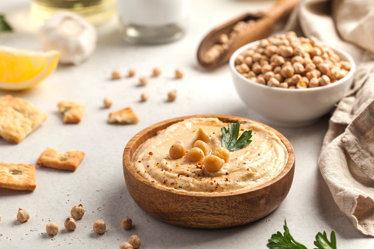 Hummus,In,A,Wooden,Plate,With,Parsley,And,Croutons.,Dishes