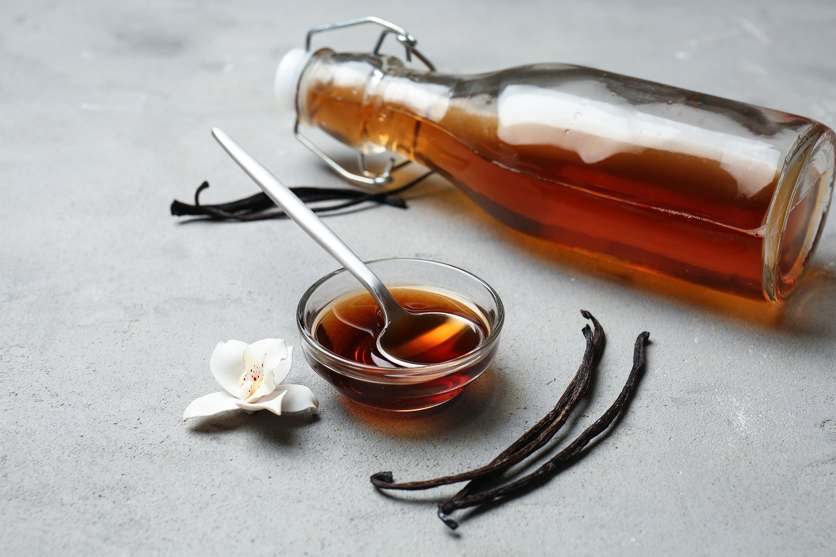 Glass,Bowl,And,Bottle,With,Vanilla,Extract,On,Table