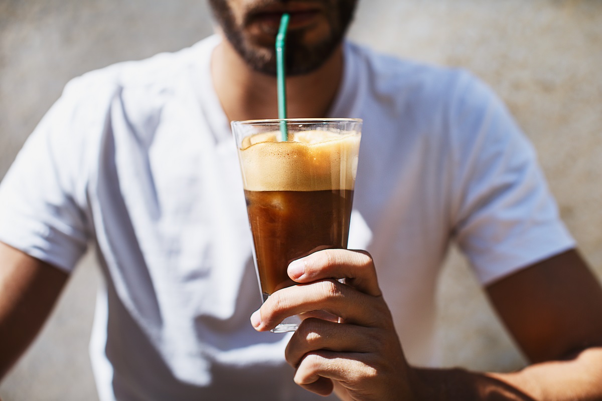 A,Man,Is,Drinking,An,Ice,Coffee,On,A,Sunny