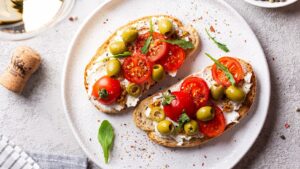 Bruschettas,With,Olives,And,Fresh,Tomatoes,And,Wineglass