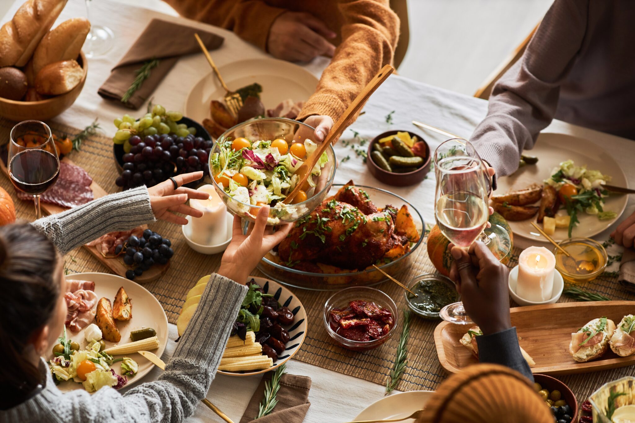 Multiethnic,Group,Of,People,At,Festive,Dinner,Table,Celebrating,Thanksgiving