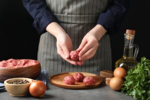 Woman,Making,Meatball,From,Ground,Meat,At,Grey,Table,,Closeup
