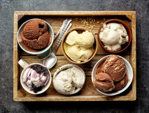 Bowls,Of,Various,Ice,Creams,On,Dark,Gray,Table,,Top