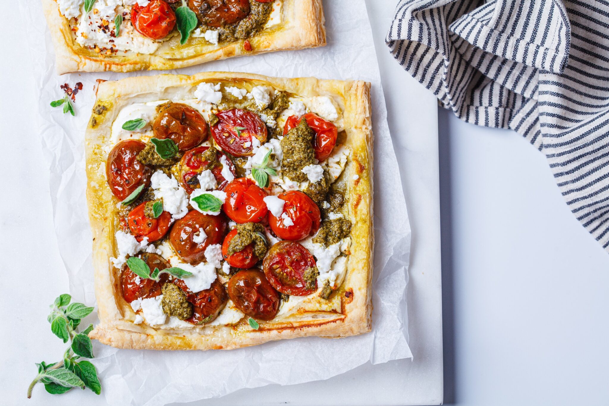 Pesto,,Tomato,And,Feta,Tarts,,Top,View.,Summer,Italian,Recipe.