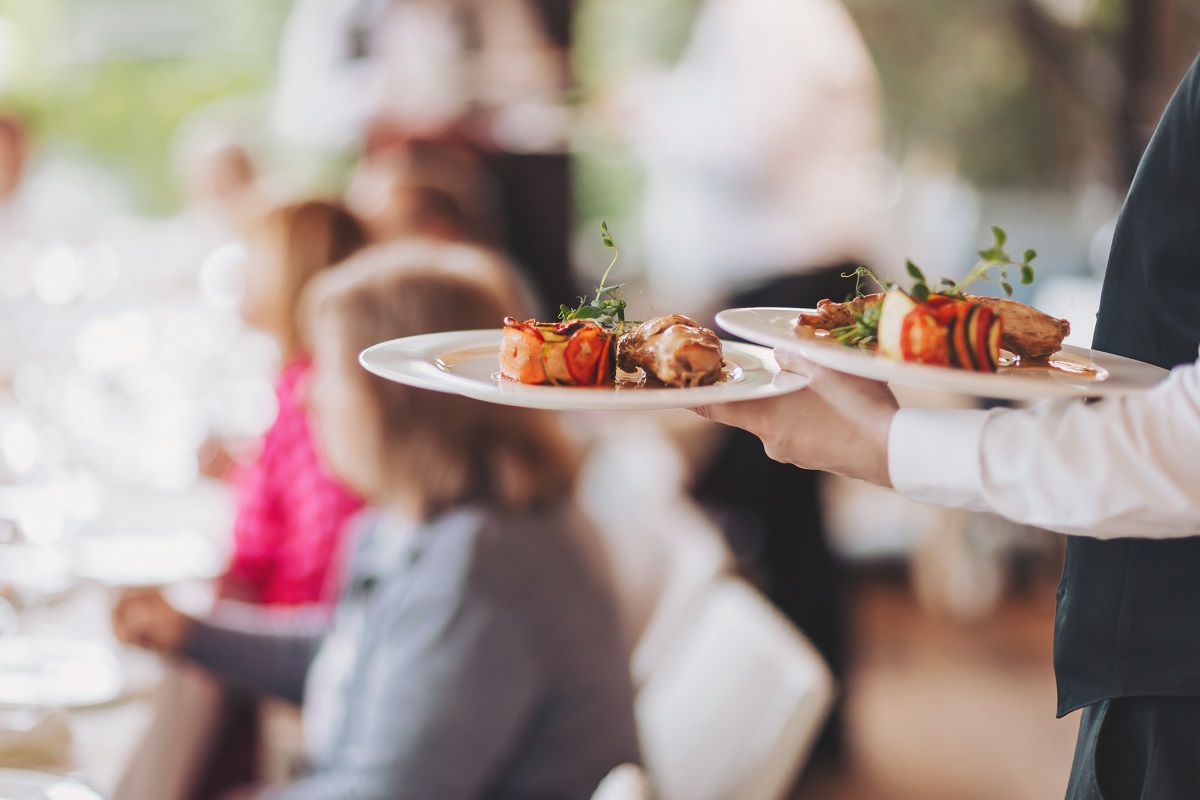 Waiter,In,A,Stylish,Uniform,Carrying,An,Exquisite,Dish,To
