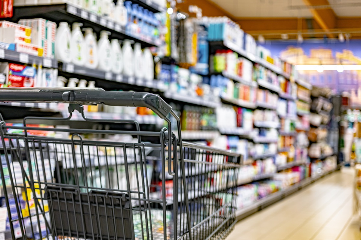 A,Shopping,Cart,By,A,Store,Shelf,In,A,Supermarket