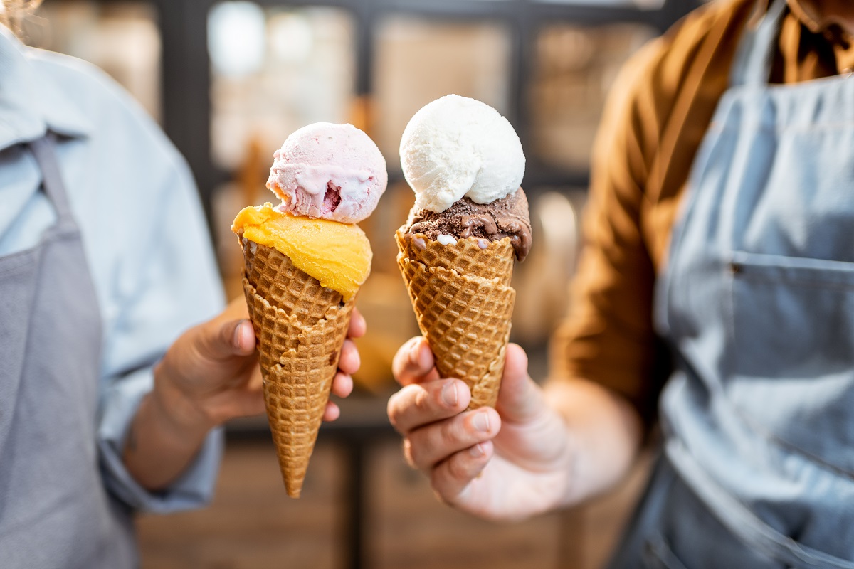 Two,Sellers,Cheering,With,Yummy,Ice,Creams,In,Waffle,Cone,