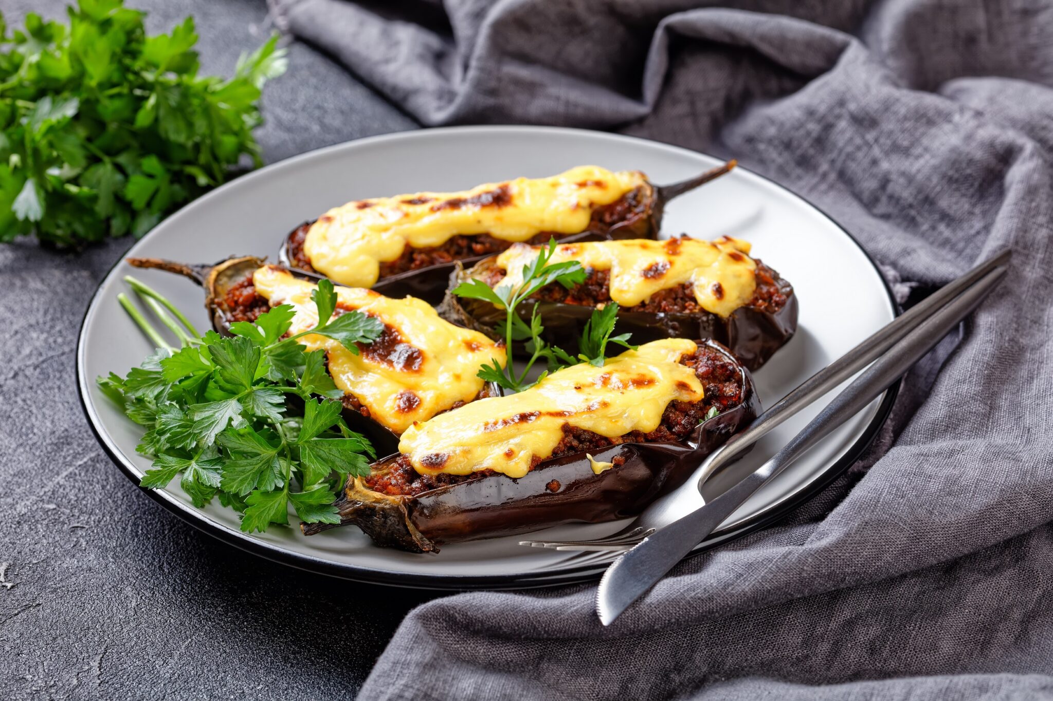 Greek,Stuffed,Eggplants,With,Ground,Beef,,Tomatoes,,Topped,With,Bechamel