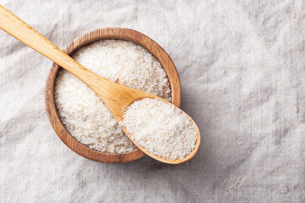 Psyllium,Husk,In,Spoon,And,Wooden,Bowl,On,Linen,Table