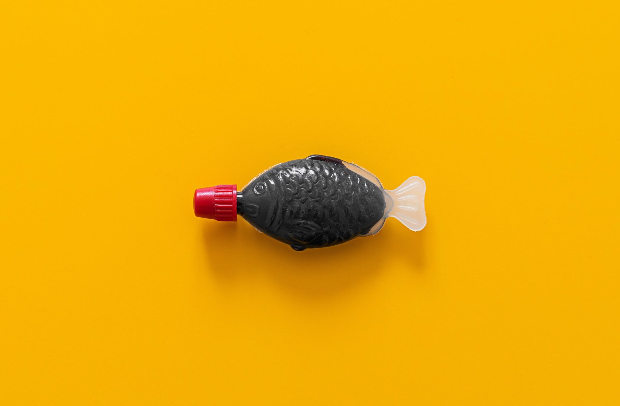 Little,Generic,Plastic,Soy,Sauce,Fish,Shaped,Container,Against,A