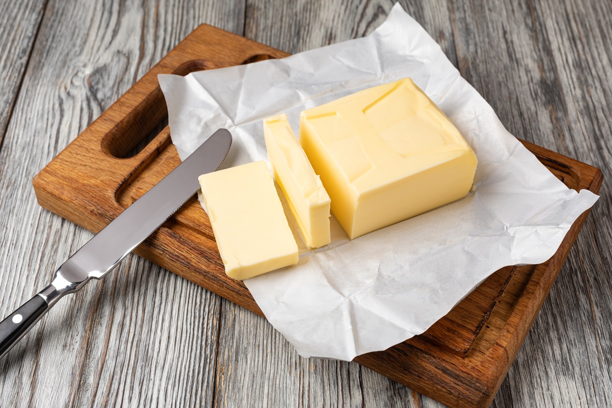 Fresh,Butter,Slices,On,A,Wooden,Cutting,Board,With,A