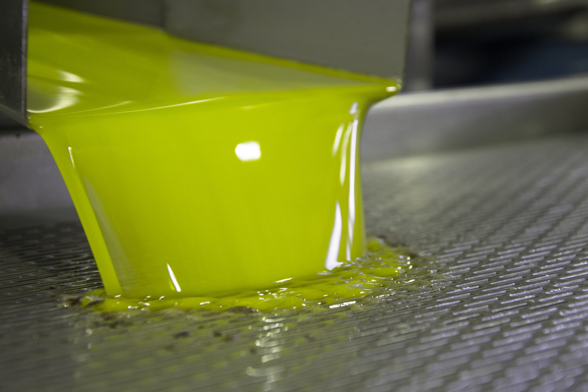 Fresh,Virgin,Olive,Oil,Pouring,Into,Tank,At,A,Cold-press