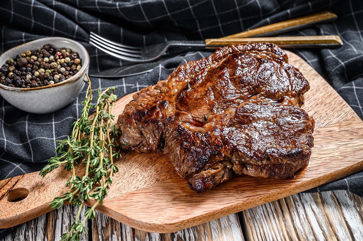 Cooked,Grilled,Chuck,Eye,Roll,Steak,On,A,Chopping,Board.
