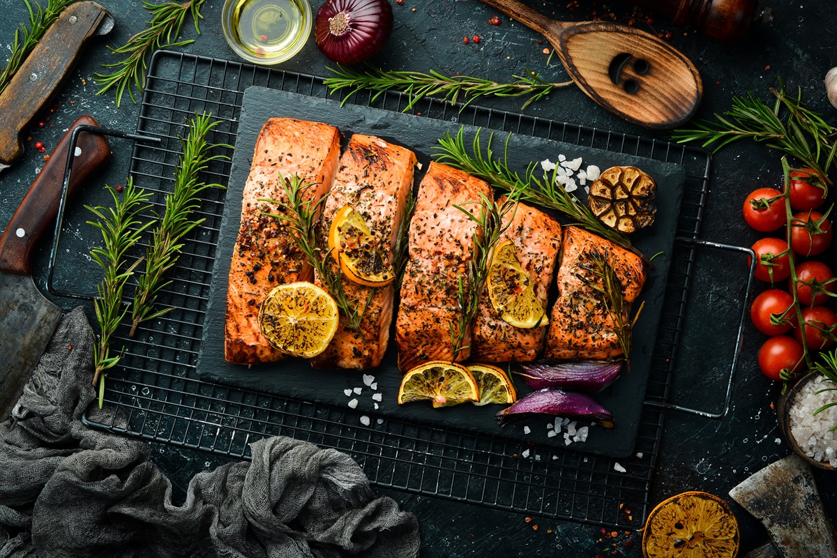Salmon.,Pieces,Of,Grilled,Fish,On,A,Black,Stone,Background.