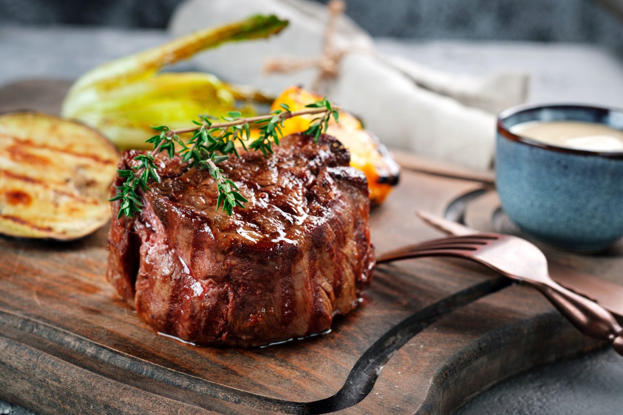 Grilled,Beef,Tenderloin,Steak,On,A,Wooden,Board,With,Grilled