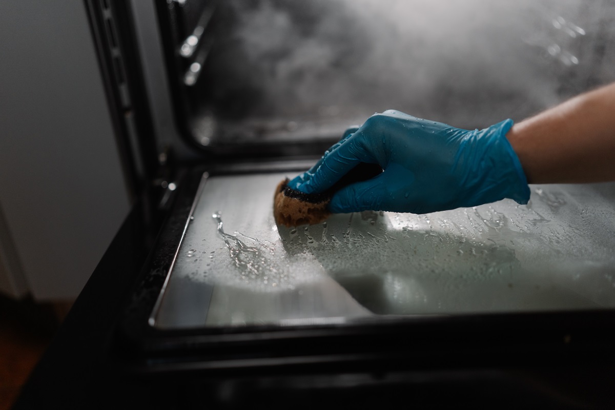 Close-up,View,Of,Cleaning,Company,Worker,Wearing,Blue,Glove,Using