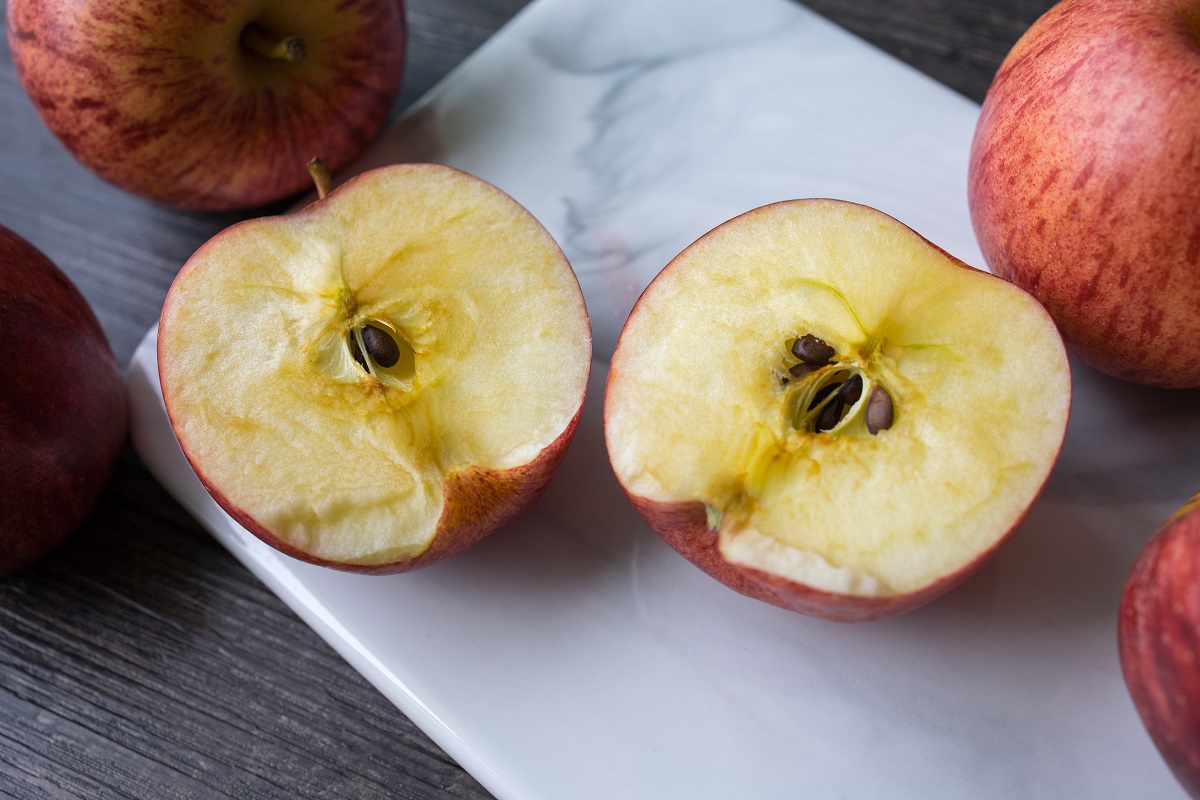 Red,Apple,Cut,Into,Half,And,Oxidised.,Turning,From,Fresh