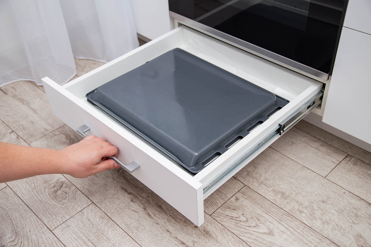 A,Man,Pulls,Out,A,Drawer,With,Baking,Sheets,In