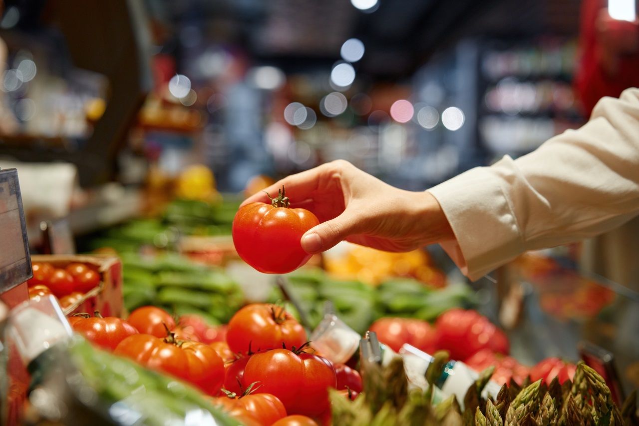 A,Person,Is,Currently,Picking,A,Ripe,,Red,Tomato,At