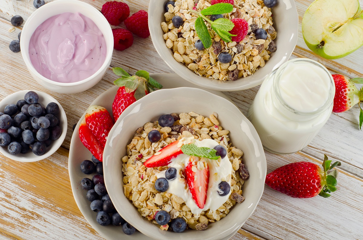 Muesli,,Fresh,Berries,And,Yogurt,For,Breakfast,On,A,Wooden