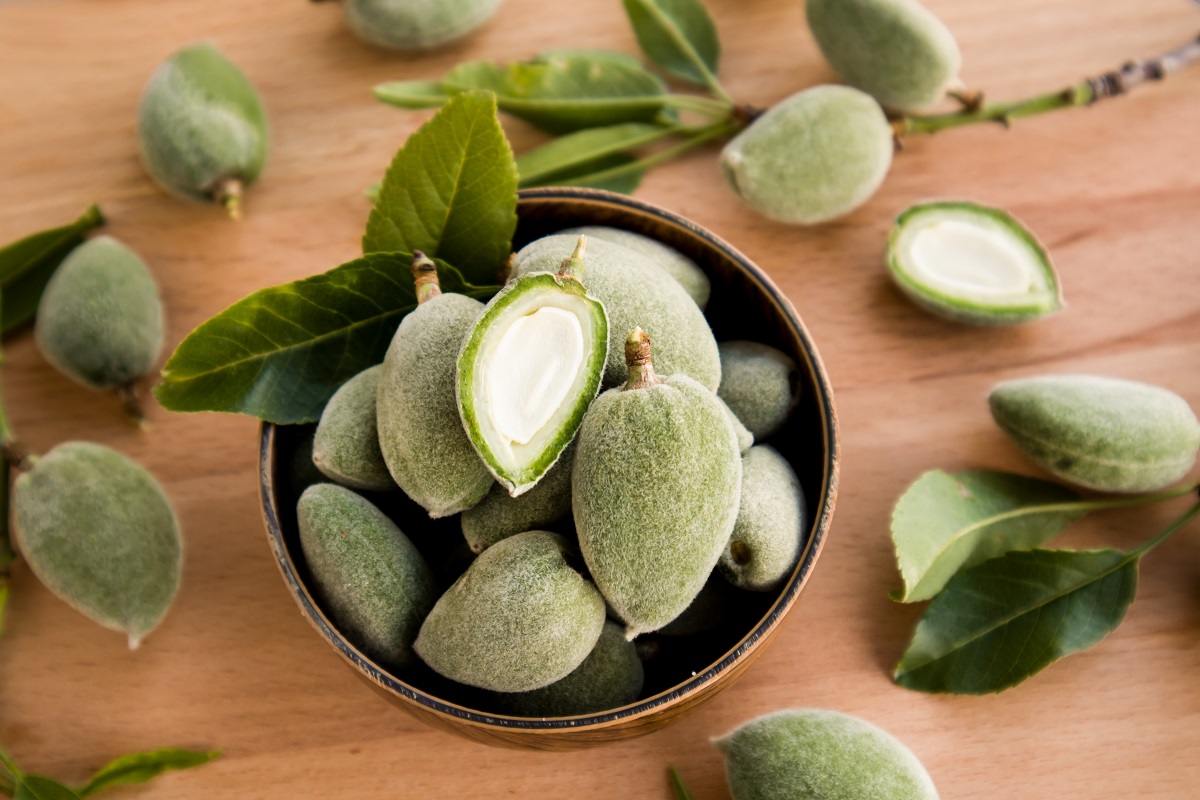 Fresh,,Unripe,Green,Almonds,In,Bamboo,Bowl,With,Sliced,And
