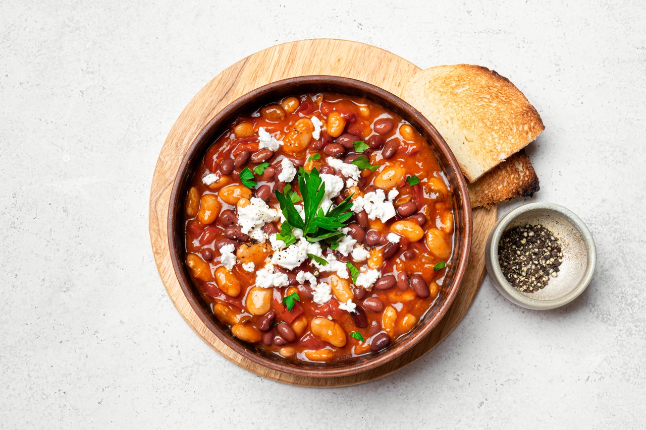 Greek,Baked,Beans,With,Feta,Cheese,And,Herbs,On,White