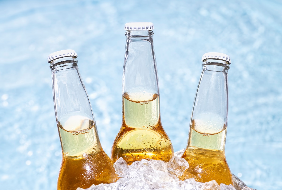 Three,Bottles,Of,Beer,With,Ice,Cubes,And,A,Pool