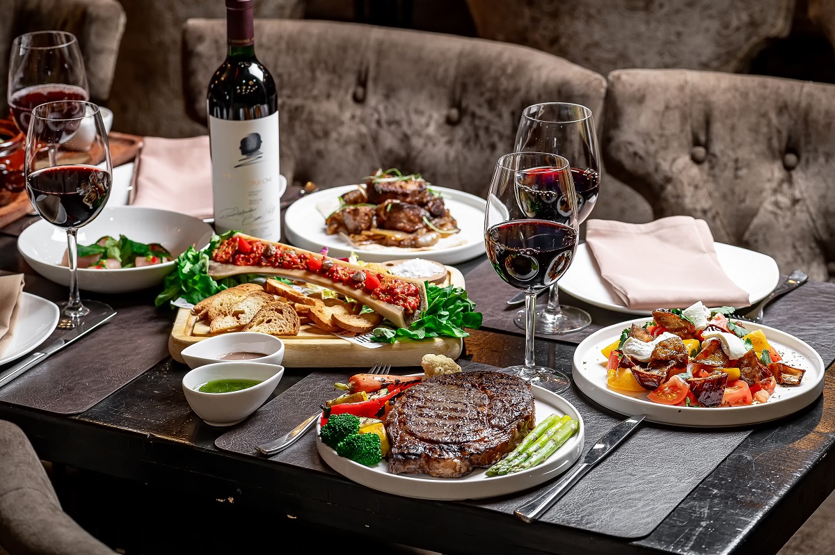Delicious,Dinner,Spread,With,Red,Wine.,A,Table,Filled,With