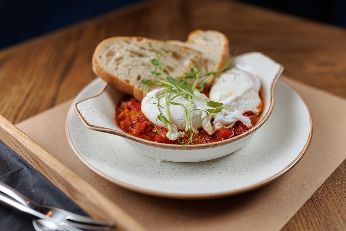 A,Plate,Holds,Two,Poached,Eggs,Placed,On,A,Flavorful
