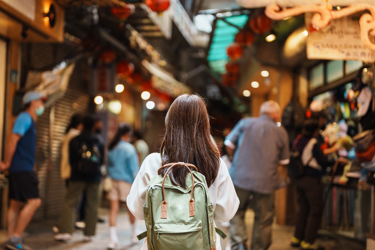 Woman,Traveler,Visiting,In,Taiwan,,Tourist,With,Hat,And,Backpack