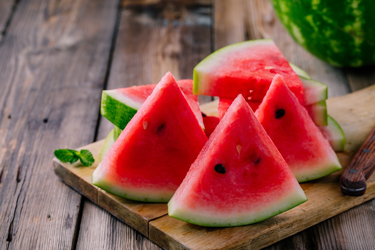Fresh,Ripe,Sliced,Watermelon,On,Wooden,Rustic,Background