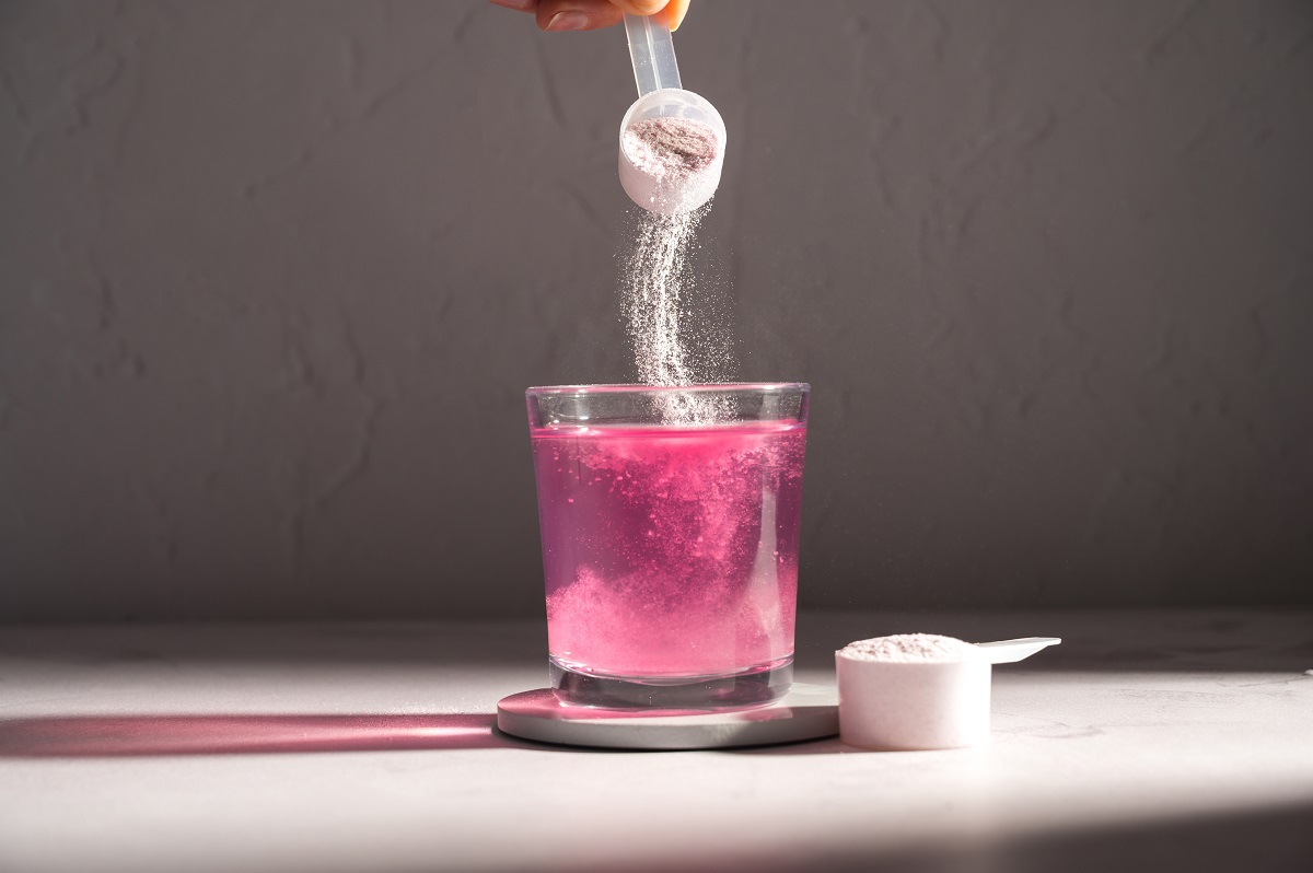 Pouring,Food,Supplement,Powder,In,Glass,Of,Water.,Collagen,,Protein