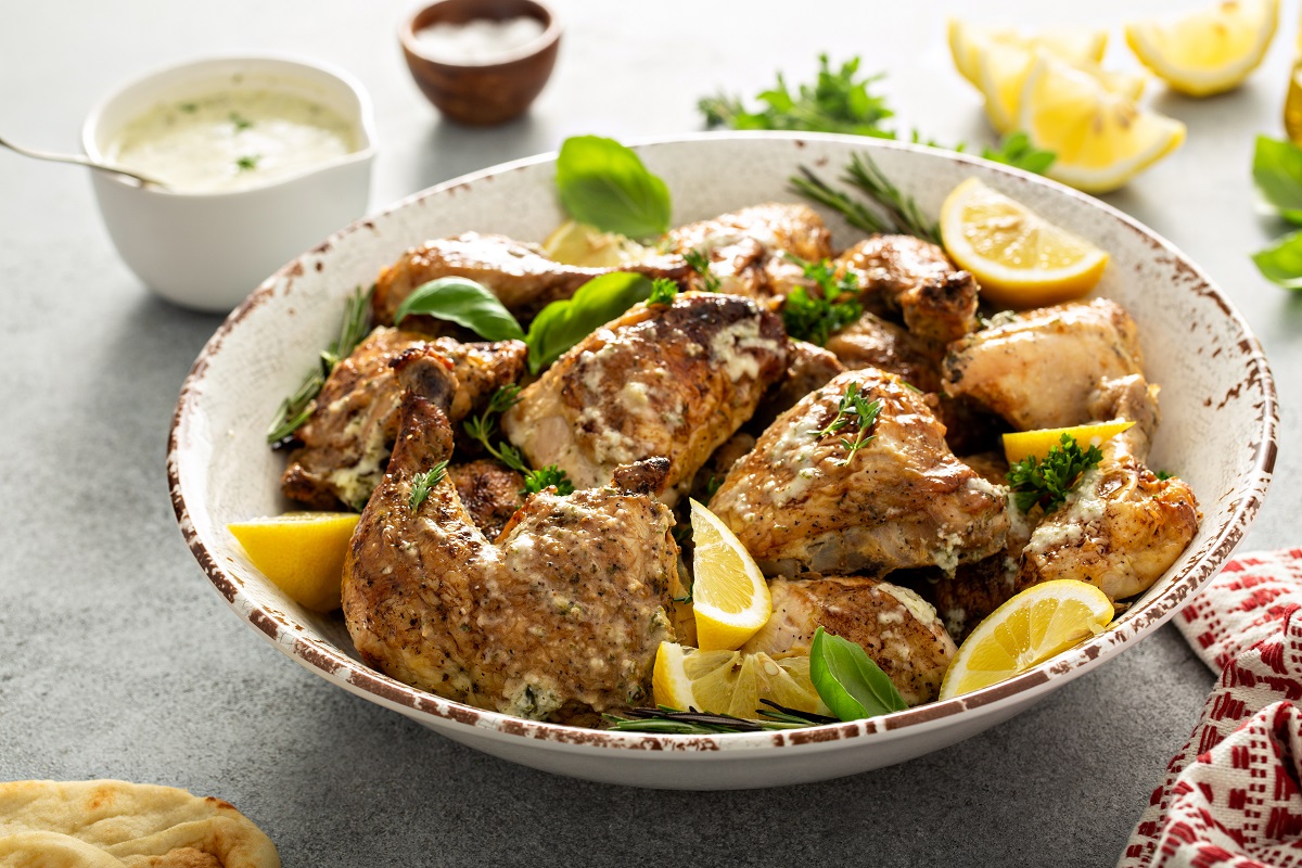 Lemon,Herbed,Garlic,Roasted,Chicken,Carved,Into,Pieces,And,Served