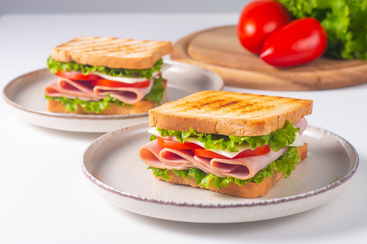 Close-up,Of,Two,Sandwiches,With,Bacon,,Salami,,Prosciutto,And,Fresh