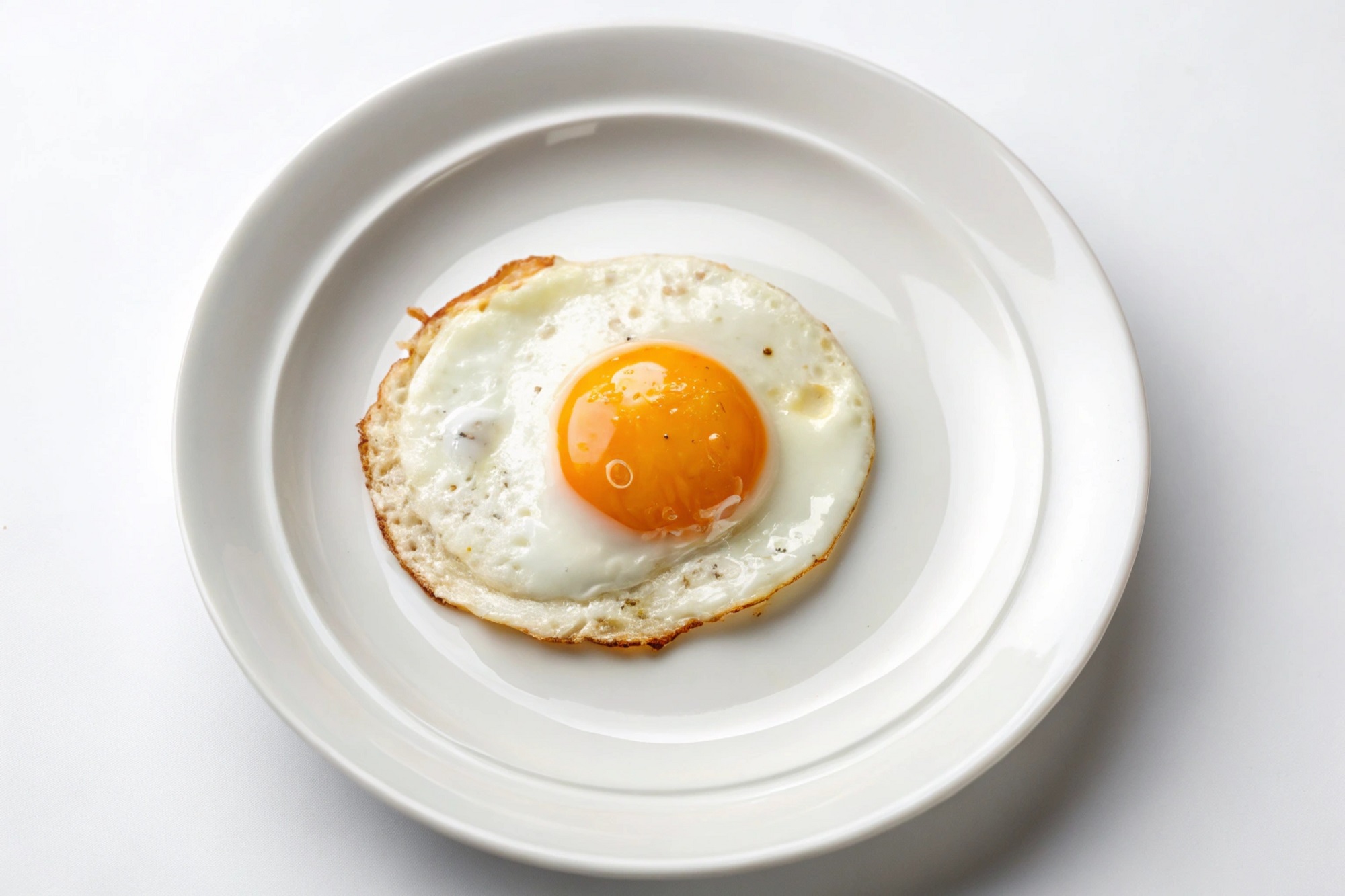 Top,View,Of,A,Sunny-side,Up,Egg,On,A,White