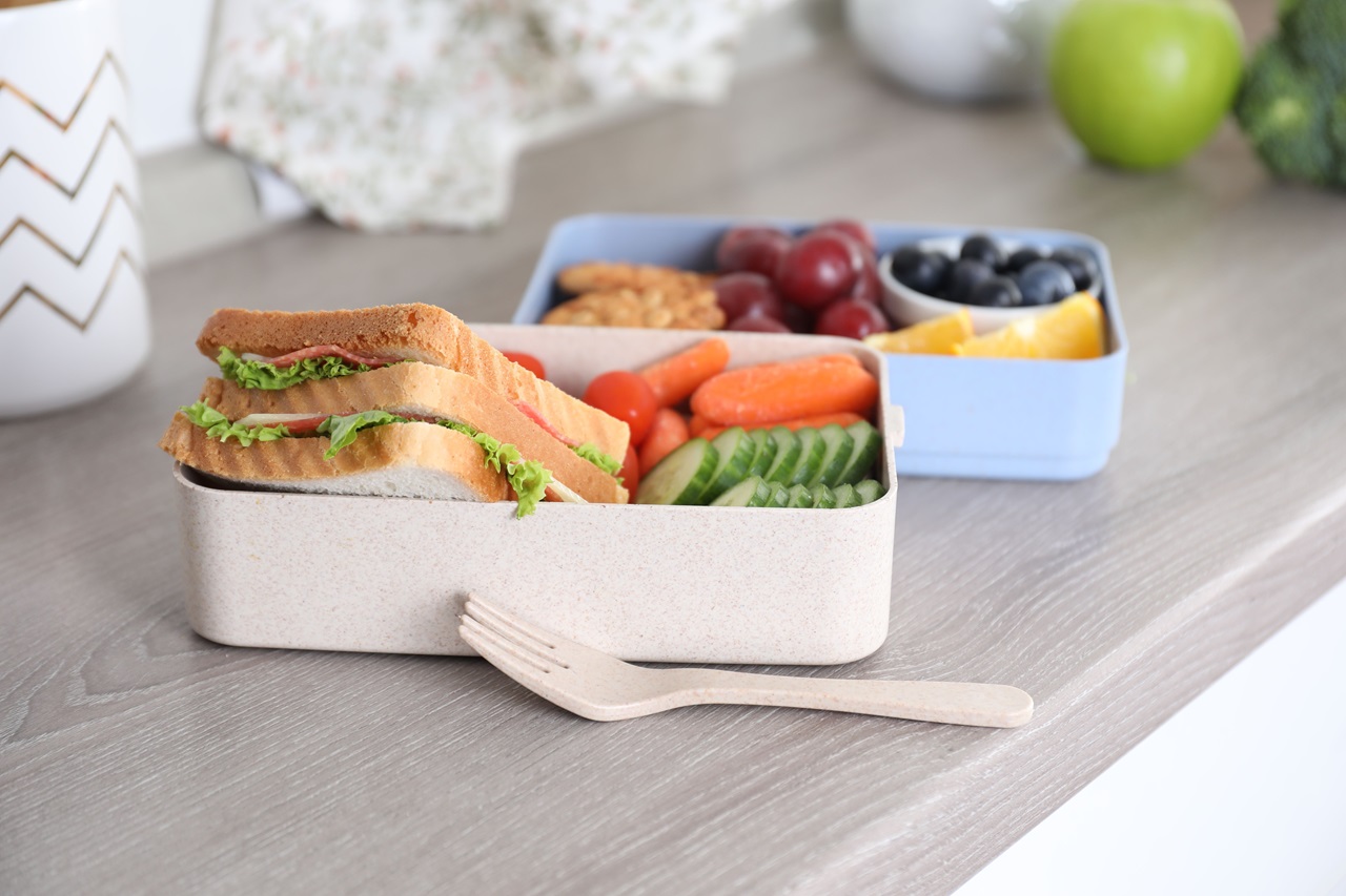 Lunch,Boxes,With,Healthy,Food,And,Fork,On,Grey,Wooden